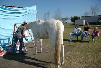 Juliet paints at her easel