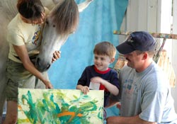 Ted Jr. poses with his new painting